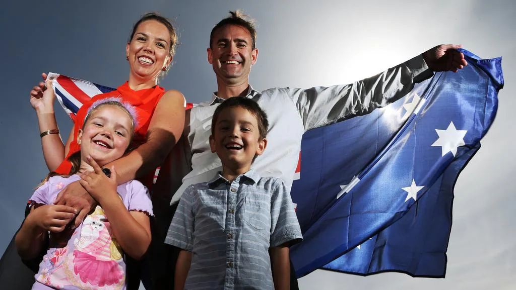 Young Family holding an Australian Flag behind them
